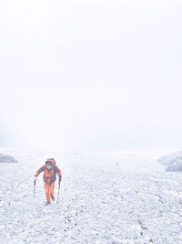 Man cycling on snow covered land