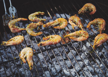 High angle view of meat on barbecue grill