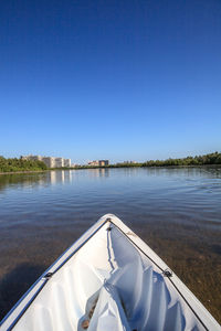 Scenic view of lake against clear blue sky