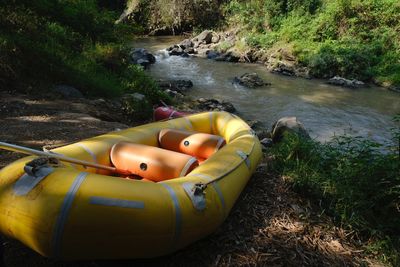 High angle view of yellow raft boat in river