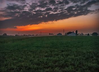 Scenic view of field against sky during sunset