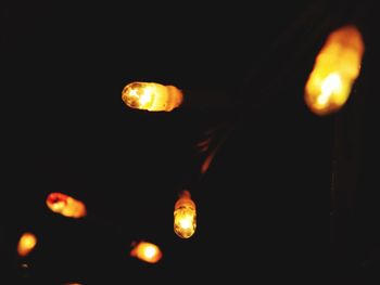 Close-up of illuminated lights in the dark