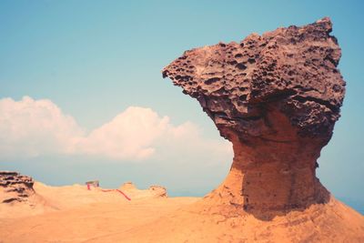 Rock formation in desert against sky