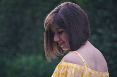 Portrait of a young woman looking down