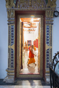 Rear view of a woman standing in temple