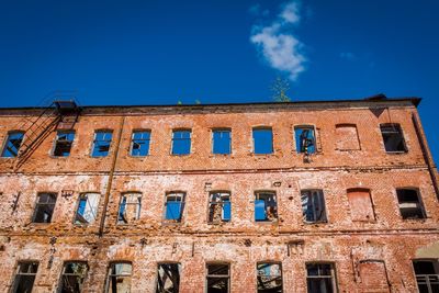 Low angle view of old building against blue sky