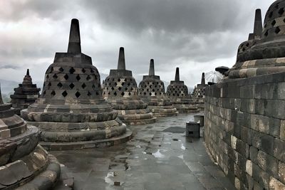 Ruins of temple against cloudy sky