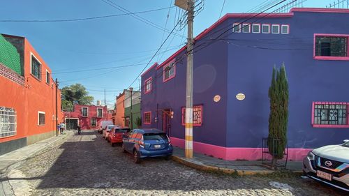 Cars on street amidst buildings in city