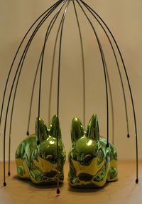 Green shiny easter bunnies on table at home