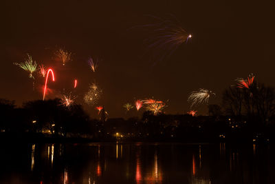 Low angle view of firework display at night