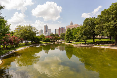 Scenic view of lake by buildings against sky