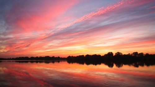 Scenic view of lake against romantic sky at sunset