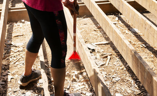 Low section of woman working at construction site