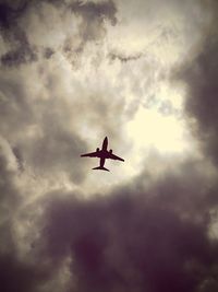 Low angle view of airplane flying in sky