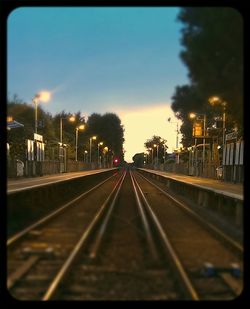 Railroad track against cloudy sky