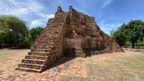 Exterior of red brick temple against sky