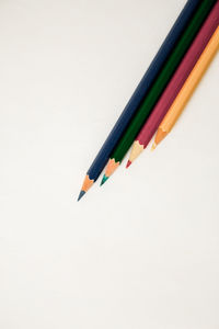 Close-up of colored pencils against white background