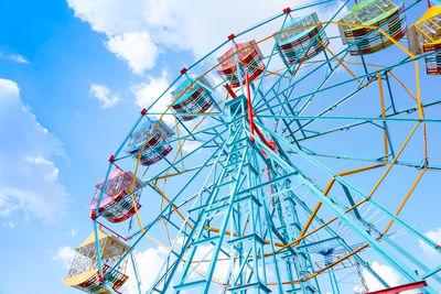 Low angle view of ferris wheel against sky