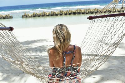 Rear view of woman standing on beach