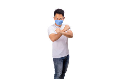 Full length of young man standing against white background