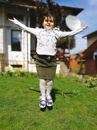 Portrait of girl levitating over field