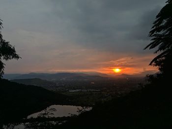 Scenic view of silhouette mountains against sky at sunset