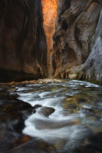 View of river flowing amidst canyon