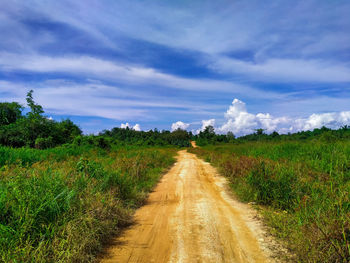 Dirt road along countryside landscape