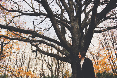 Low angle view of bare tree in forest