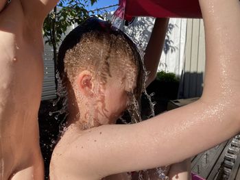 Close-up of wet hands in bathroom