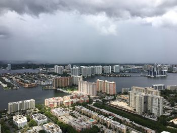 High angle view of cityscape by sea against sky