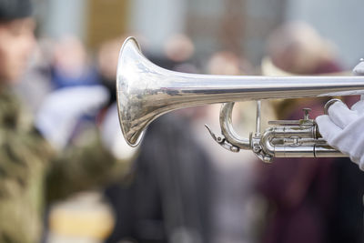 Close-up of person hand holding musical equipment outdoors