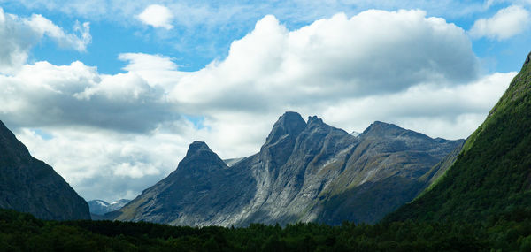 Scenic view of mountains against cloudy sky