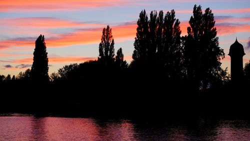 Silhouette trees against sky during sunset