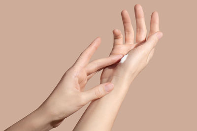 Hands of a young woman applying the cream. skincare concept. high quality photo