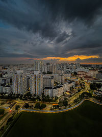 High angle view of illuminated cityscape against sky during sunset
