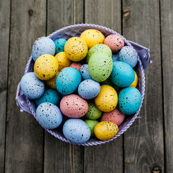 Close-up of multi colored eggs on wooden table