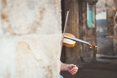 Cropped image of man playing violin