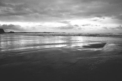 Scenic view of sea against cloudy sky