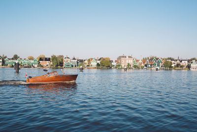 Boat on river against clear sky