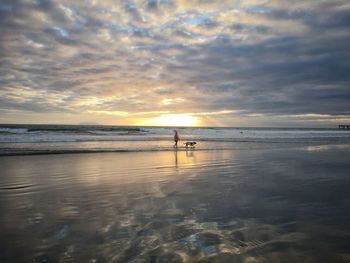 Scenic view of calm sea against cloudy sky