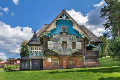 Wooden house teremok, decorated with carvings based on russian epics, flenovo, russia