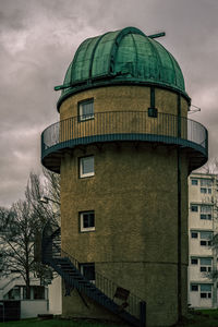 Low angle view of building against cloudy sky