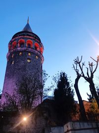 Low angle view of illuminated building against sky