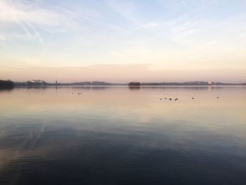 Scenic view of lake against sky during sunset