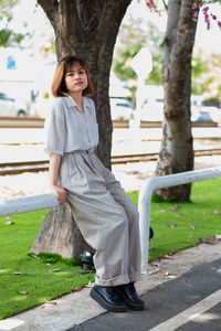 Portrait of smiling girl standing against trees