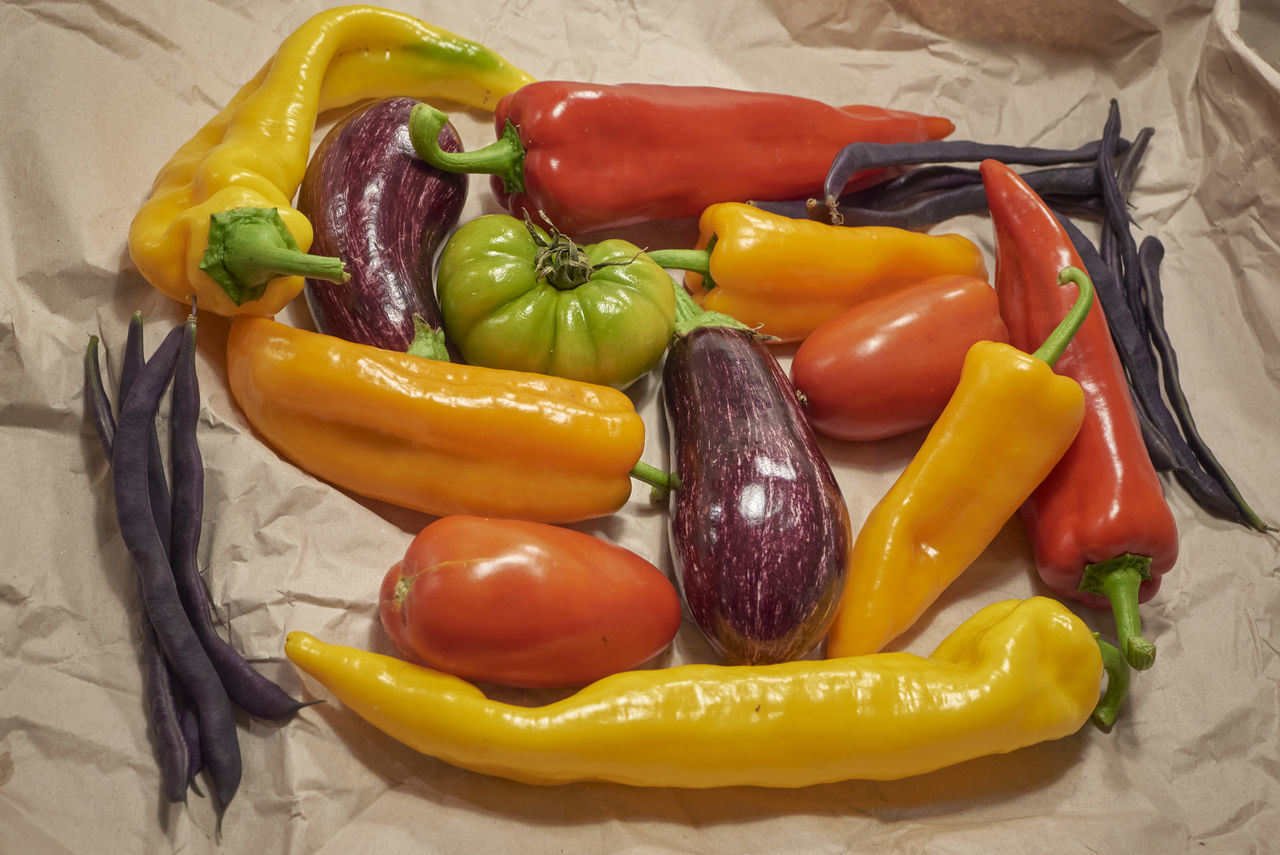 HIGH ANGLE VIEW OF VEGETABLES AND YELLOW BELL PEPPERS IN CONTAINER