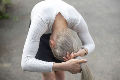 Midsection of woman with arms raised