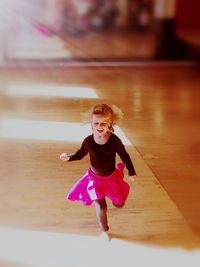 Girl looking away while standing on floor