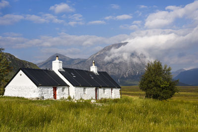 House on field against sky